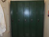 a green locker in the corner of a room