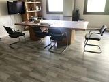 a table with chairs and a television in a room