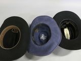 several hats are lined up on a white surface