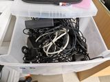 a plastic container filled with wires and cords in it