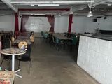 a room with tables and chairs in it that is empty