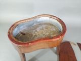 a small wooden table with a bowl on top of it