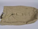 beige canvas bag with metal handles on white surface