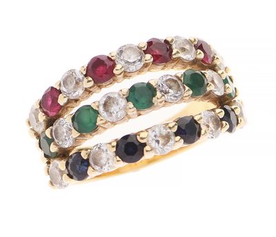un gros plan d'une bague ornée de pierres de différentes couleurs