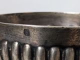 a silver bowl that is sitting on a table
