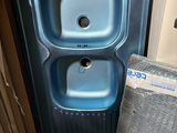 a blue sink and a toilet in a small room
