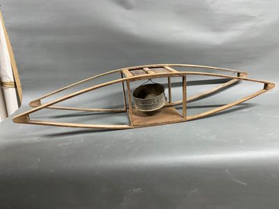 a small wooden boat with a bell on it