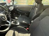 the interior of a car with black seats and a steering wheel