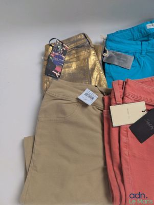 three pairs of women ' s pants with tags and tags on them