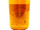 a close up of a bottle of alcohol on a white surface