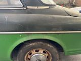 a green and black car parked in a parking lot