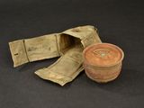 a small pot and a small bag on a table