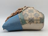 a blue and white bag with a tassel on top of it