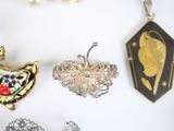 many different types of jewelry displayed on a white surface