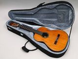 a guitar in a case on a white surface