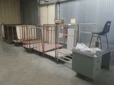 a room with a lot of beds and a chair in it