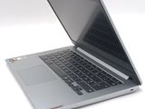 a silver laptop with a black keyboard on a white surface