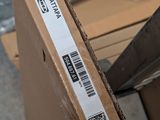 a cardboard box with a sticker on it sitting on the ground
