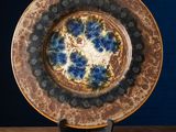 an image of a blue and brown plate on a wooden table