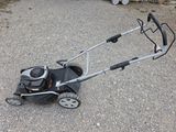 a lawn mower that is sitting on the ground