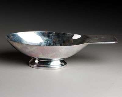 an image of a silver bowl with a spoon sticking out of it
