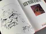an open book with a drawing of a lion on it