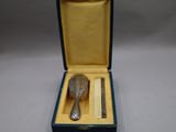 a silver spoon and a pair of scissors in a blue box