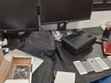 a desk with two monitors and a laptop on it
