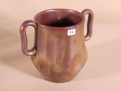 a brown vase with two handles and a tag on it