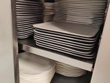 many plates stacked on top of each other in a cabinet