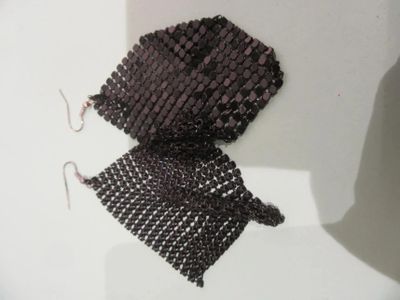 a pair of earrings made out of beads on a mannequin mannequin mannequin mannequin mannequin mannequin manne