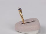 a gold ring with a blue stone on top of it
