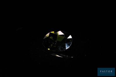 a diamond in the dark with a black background