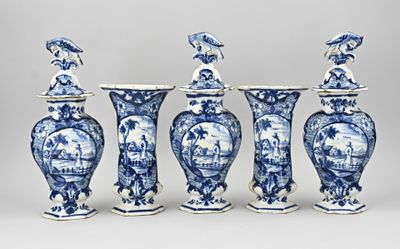 four blue and white vases with birds on them sitting on a table