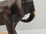 a statue of an elephant that is standing on a rock