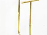 brass plated towel stand with two towel bars on top of it