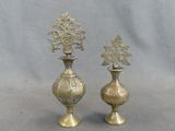 two gold vases sitting next to each other on a table