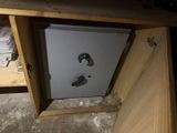 a white refrigerator sitting inside of a wooden cabinet