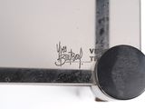 a close up of a metal object with graffiti on it