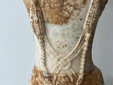 statue of a woman with a necklace on her neck and a necklace around her neck