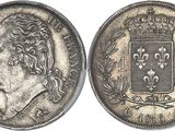 a silver coin with a crown on top of it