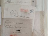many old letters and envelopes on a shelf
