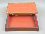 a small wooden box with a lid on a white surface