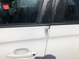a white car with a broken door handle and a broken window