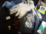 a pile of clothing and a dvd on the floor