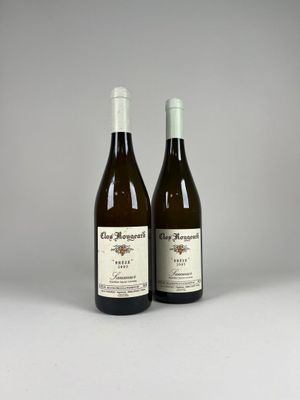 two bottles of wine sitting next to each other on a table