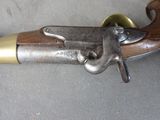a very old gun that is laying on a table