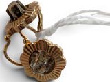 a close up of a gold ring with a flower on it