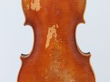an old violin sitting on top of a wooden stand