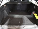 the back of a car with the trunk open and a yellow glove in the trunk